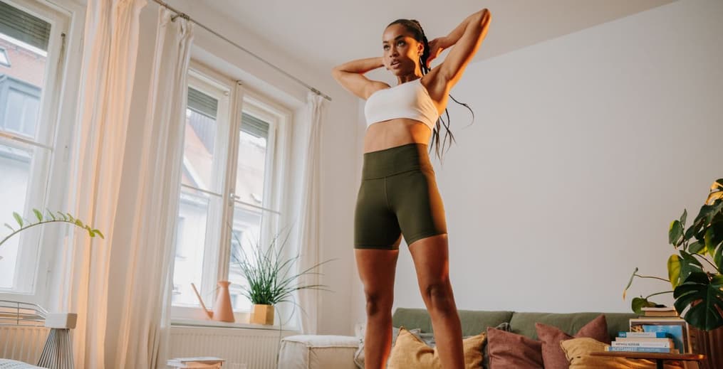Person doing burpees in their living room after eating a pre-workout meal