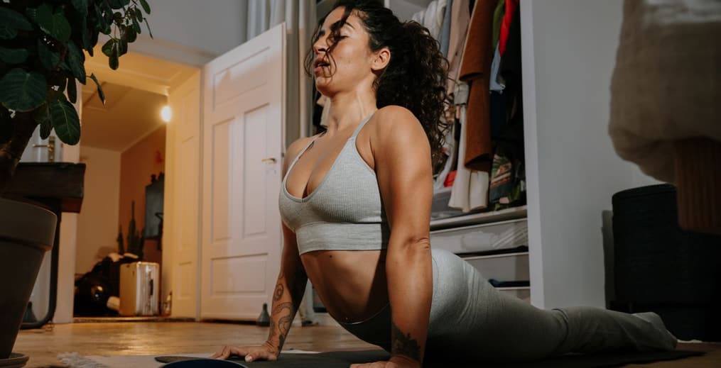 Person doing gentle evening yoga at home to relax and improve sleep quality