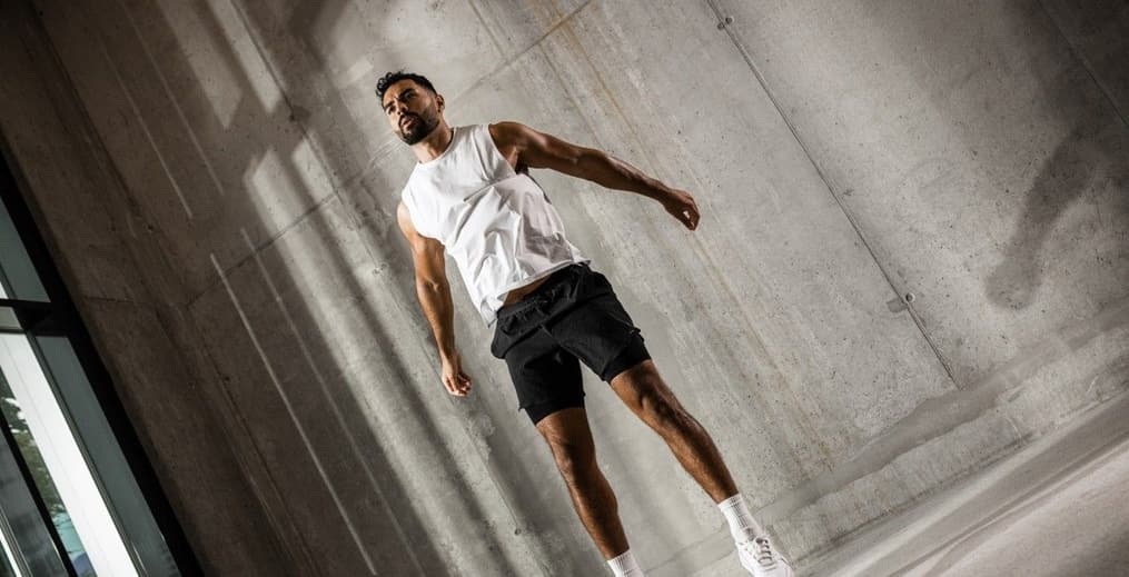 Man mid-jump during a high-intensity bodyweight Freeletics God workout