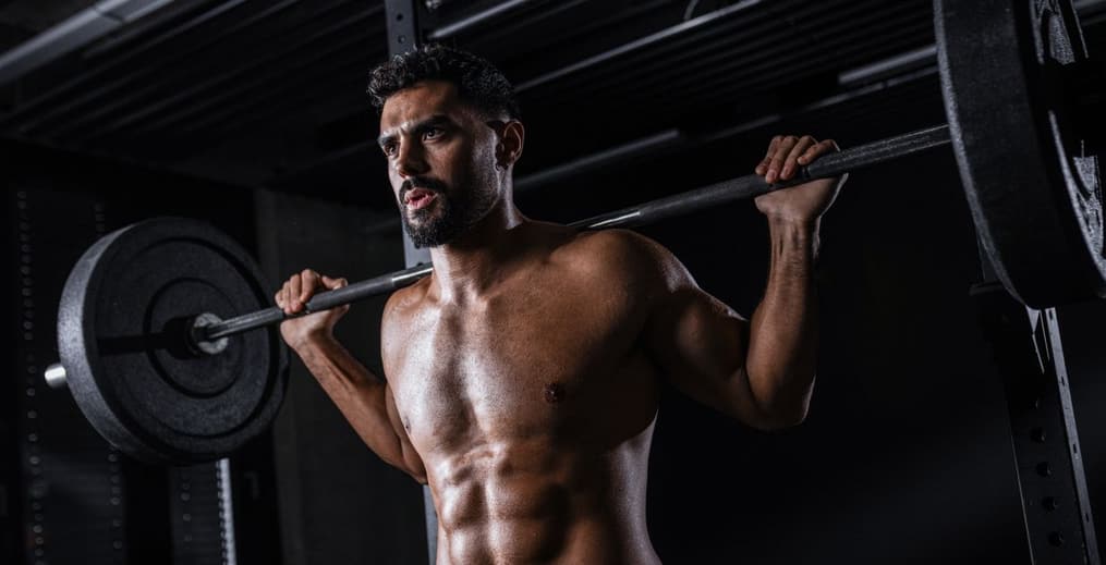 Athlete preparing for a heavy back squat to illustrate the difference between performance training and aesthetic goals.