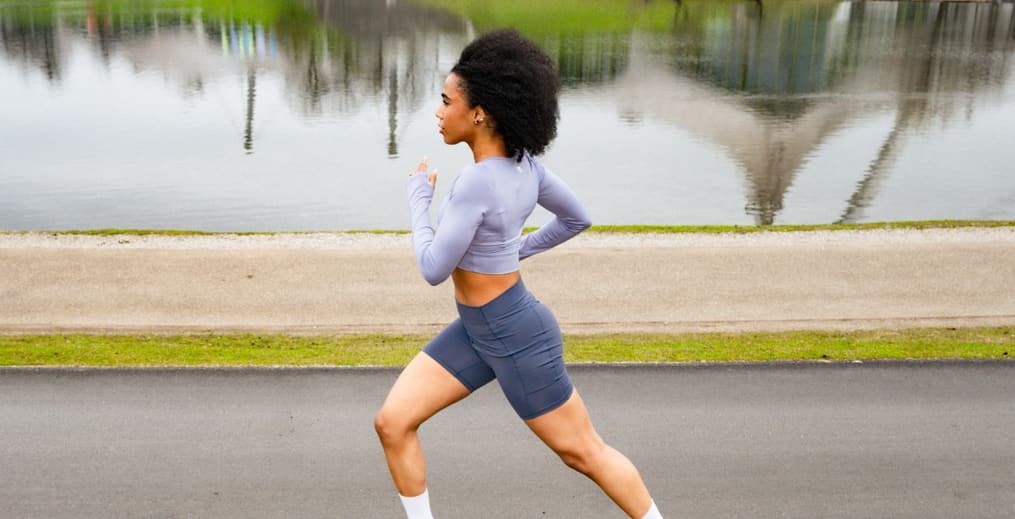 Athlete running outside in an urban setting, showcasing the benefits of cardiovascular exercise.