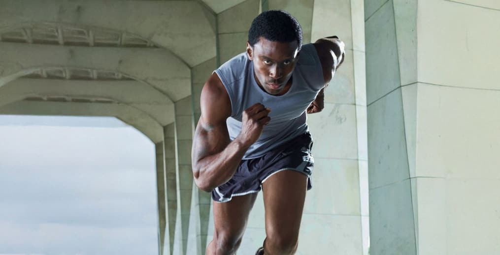 Athlete sprinting on a track as part of a sports conditioning workout
