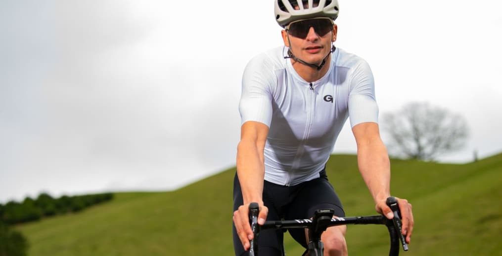Athlete cycling outdoors, representing Zone 2 training for endurance and health.