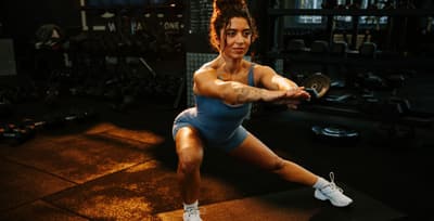 Focused athlete performing intense bodyweight exercises in a gym setting