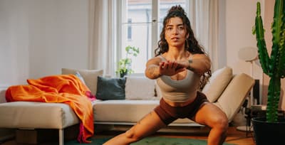 Athlete performing a side lunge, showcasing functional movement and fascial engagement