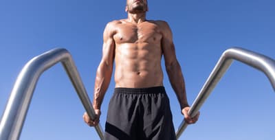 Athlete performing dips on dip bars to build upper body strength
