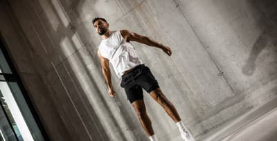 Man mid-jump during a high-intensity bodyweight Freeletics God workout
