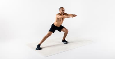 Person doing gliding side lunges with exercise sliders for strength and balance training