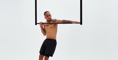 Athlete performing typewriter pull-ups to build bodyweight strength using the greasing the groove method.
