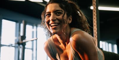 Woman smiling after a workout, showing the mood boost from exercise and happy hormones.
