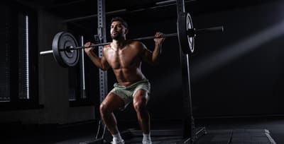 Athlete performing a heavy compound lift as part of a hypertrophy training program to build muscle