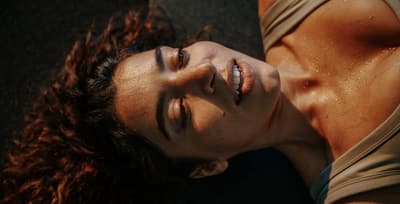 Athlete resting on a mat after an intense workout to support muscle regeneration