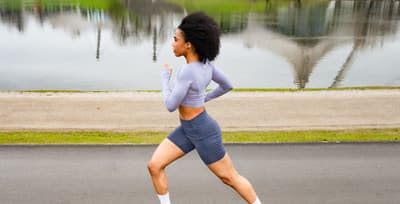 Athlete running outside in an urban setting, showcasing the benefits of cardiovascular exercise.