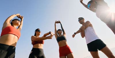 Focused runners grouped at the starting line of a marathon, representing peak physical race preparation.