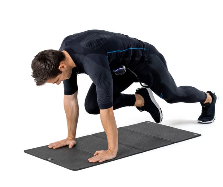 Athlete doing Mountain Climbers while wearing an EMS suit to add intensity to bodyweight training