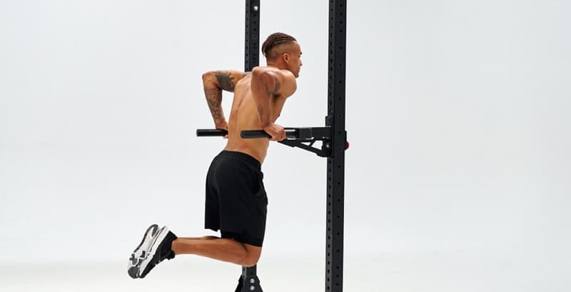 An athlete performing parallel dips as part of a calisthenics workout.
