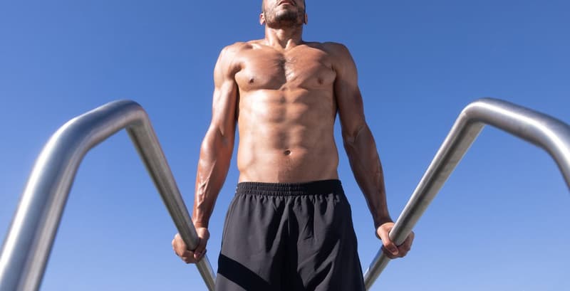 Athlete performing dips on dip bars to build upper body strength