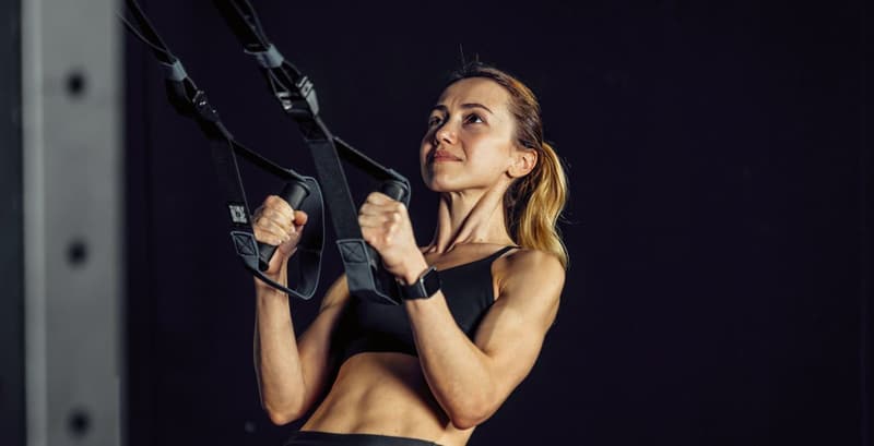 Athlete performing suspension training for a full-body workout