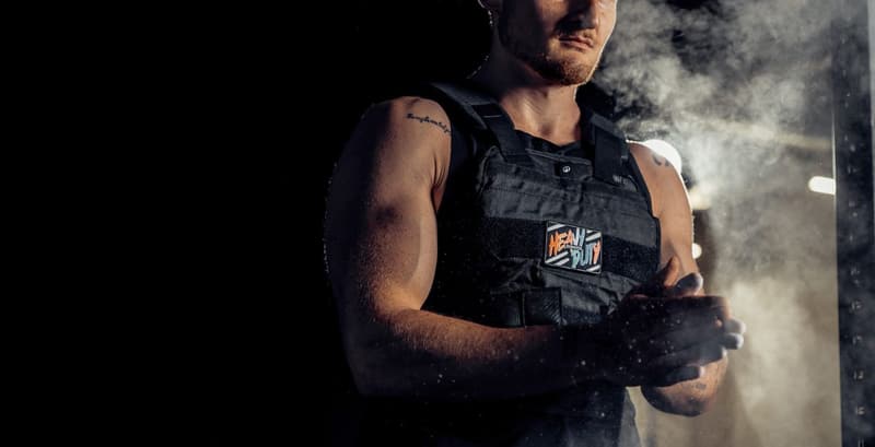 Athlete wearing a weighted vest during a workout, demonstrating the benefits of added resistance for strength and endurance training.