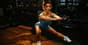 Focused athlete performing intense bodyweight exercises in a gym setting