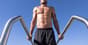 Athlete performing dips on dip bars to build upper body strength