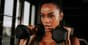 Athlete in a gym holding dumbbells, symbolizing focus and determination to achieve fitness goals.