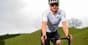Athlete cycling outdoors, representing Zone 2 training for endurance and health.